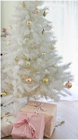 White christmas tree with gold decorations and pink gifts underneath